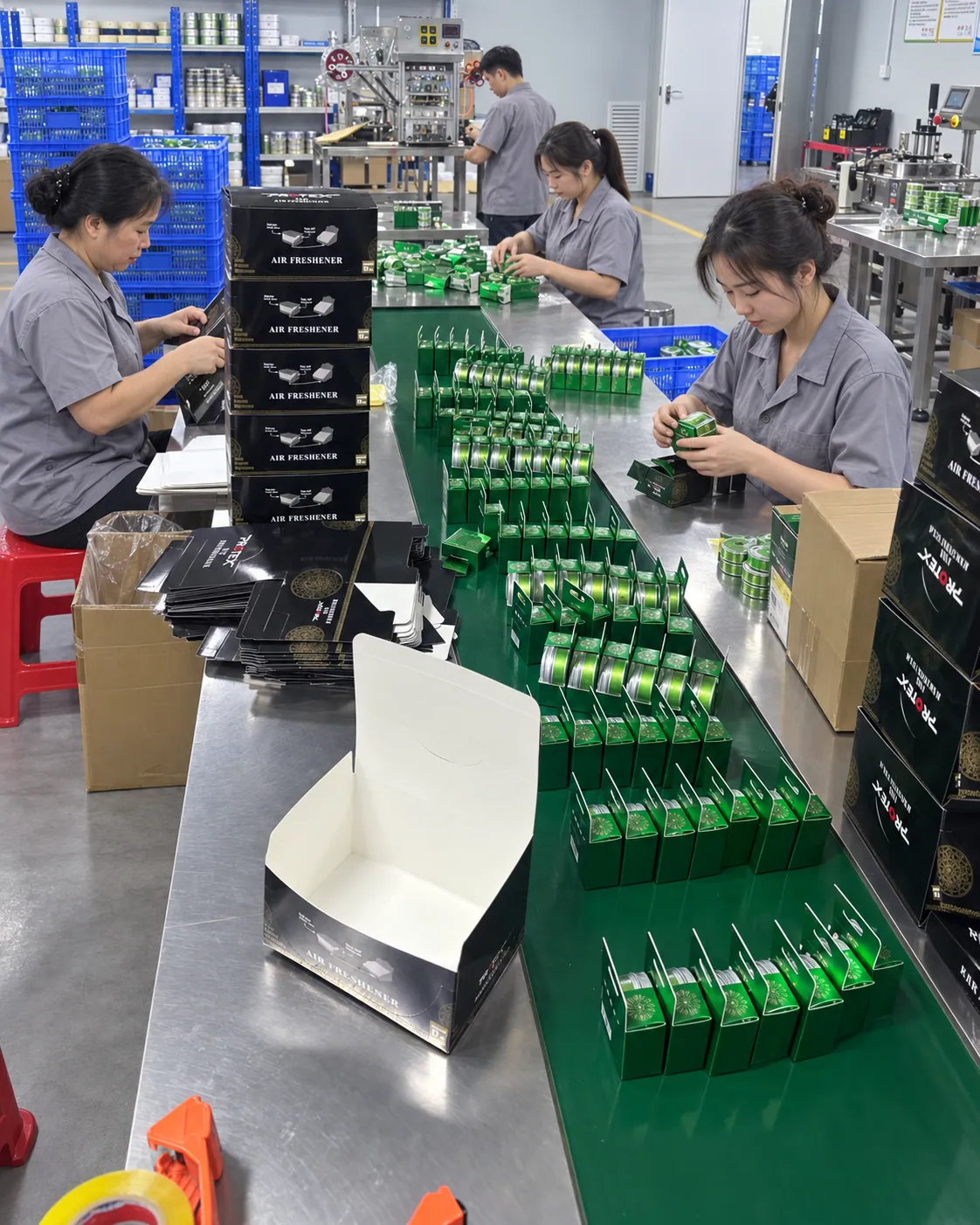 Workers packing fragrance tins into boxes